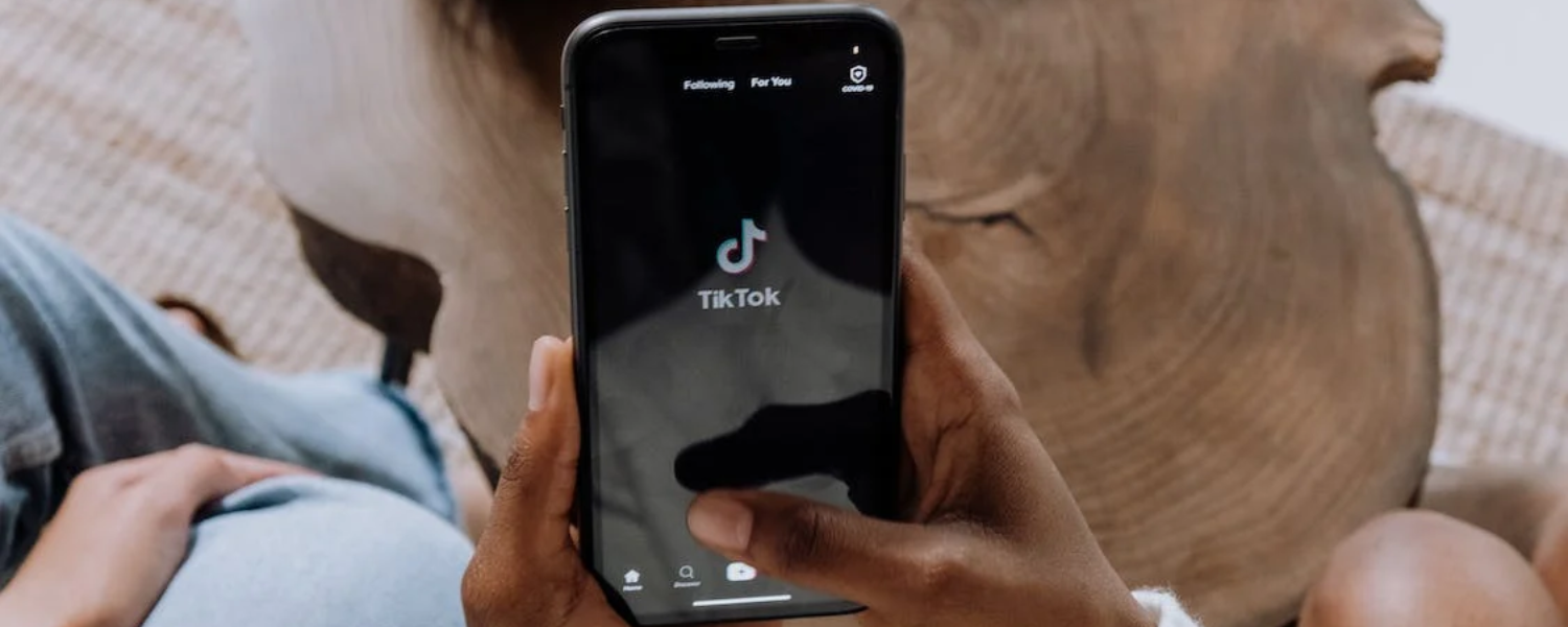 Person holding phone with TikTok
